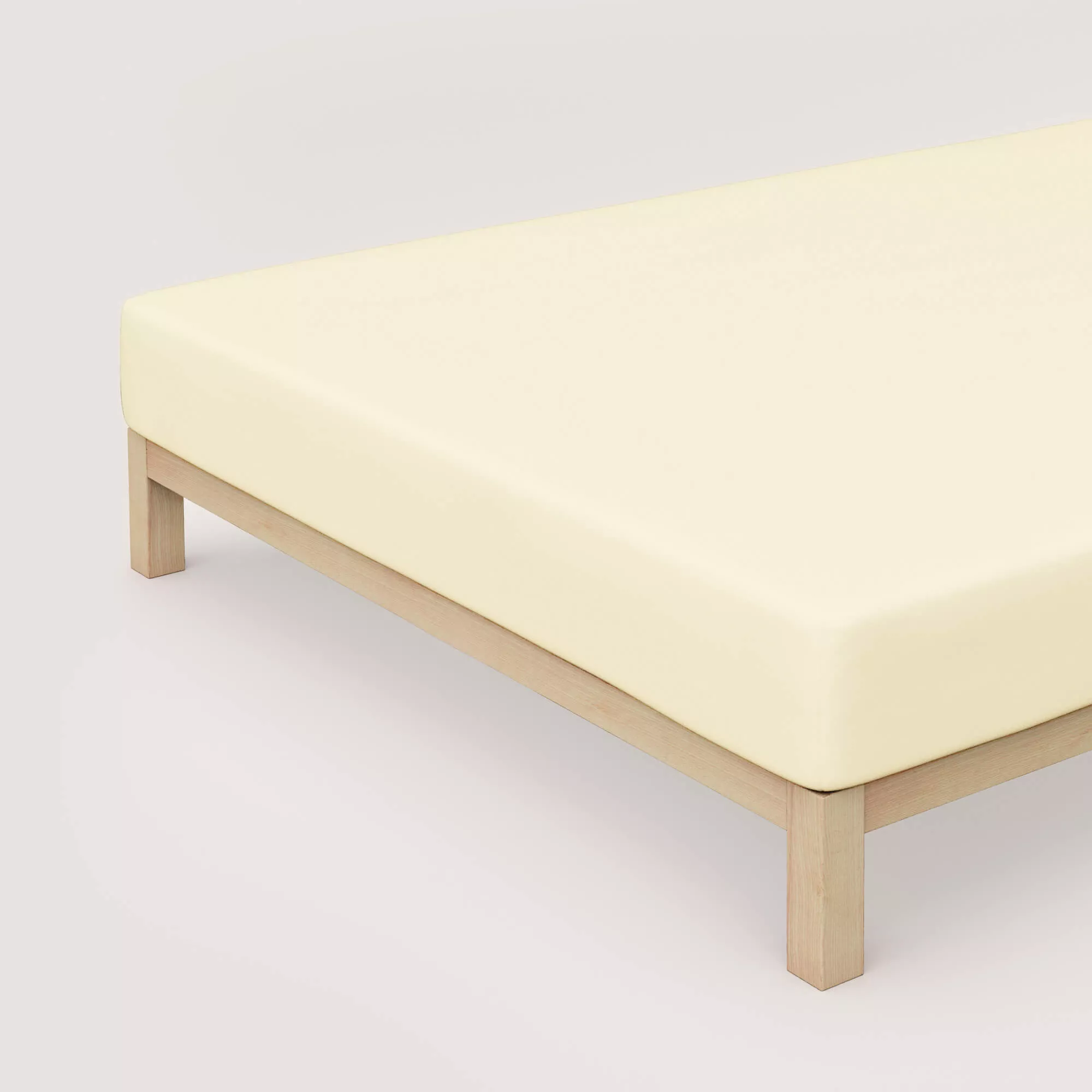 Spannbettlaken Pure von Schlafgut in Farbe yellow light aus 95% Bio-Baumwolle und 5% Elasthan auf Bett in Vogelperspektive