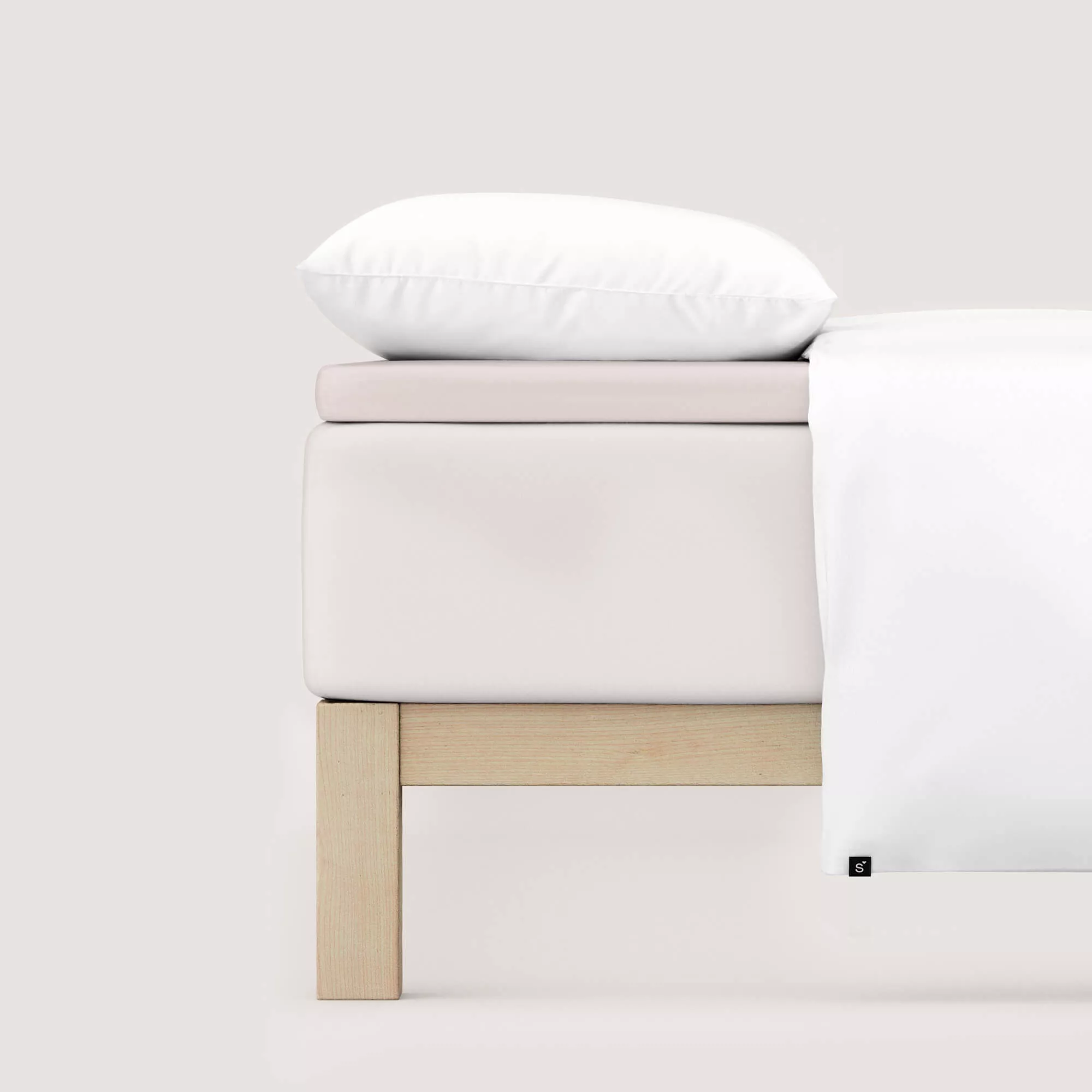 Spannbettlaken Pure Topper von Schlafgut in Farbe sand light aus 95% Bio-Baumwolle und 5% Elasthan auf Bett seitlich